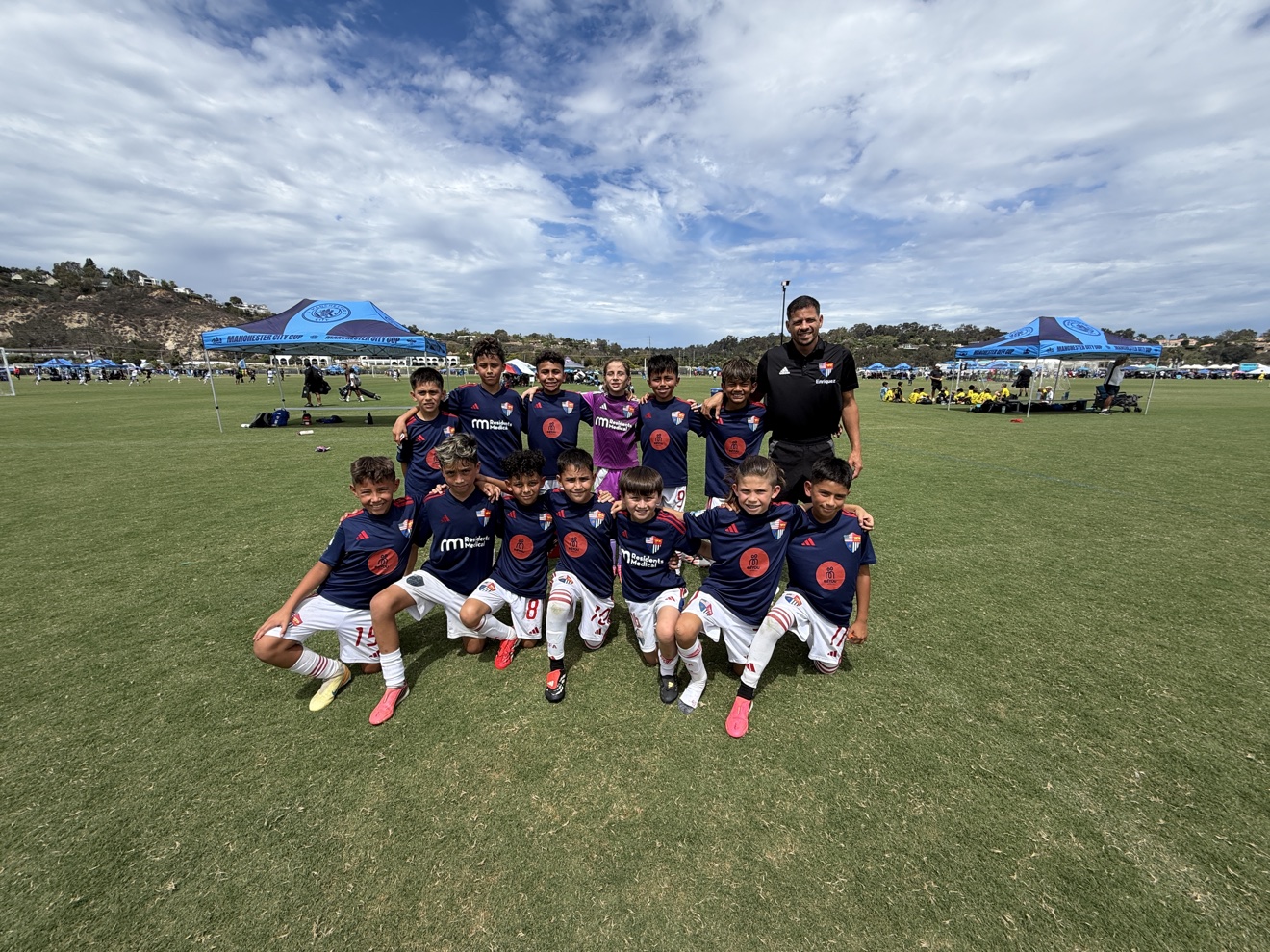 Total Futbol Academy U11 EA team in navy jerseys together on the field